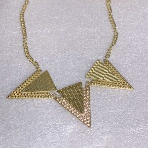 Gold tone chest piece with pink accented stones